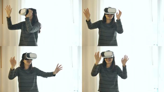 女人使用虚拟现实美丽的年轻女性在VR眼镜中玩游戏