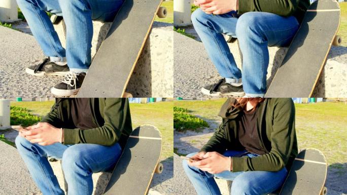 年轻的白人男子坐在人行道上发短信的侧视图4k