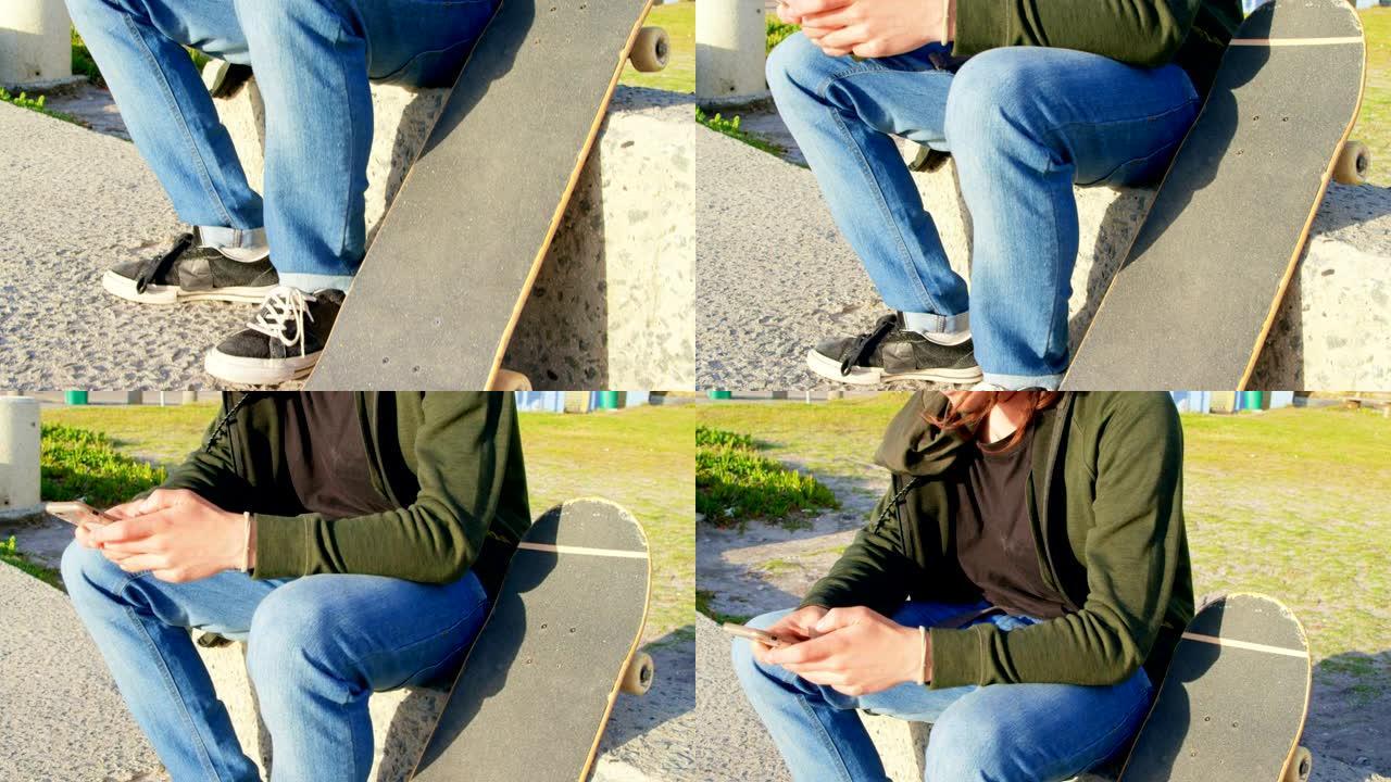 年轻的白人男子坐在人行道上发短信的侧视图4k
