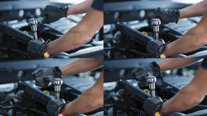 慢动作特写镜头，一名专业机械师在汽车维修中工作。发动机专家固定电机。修理工戴着手套，用棘轮。现代清洁