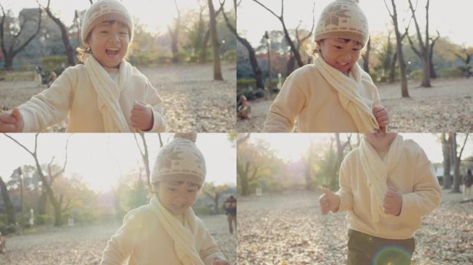 可爱的小男孩在秋天在公园跑步