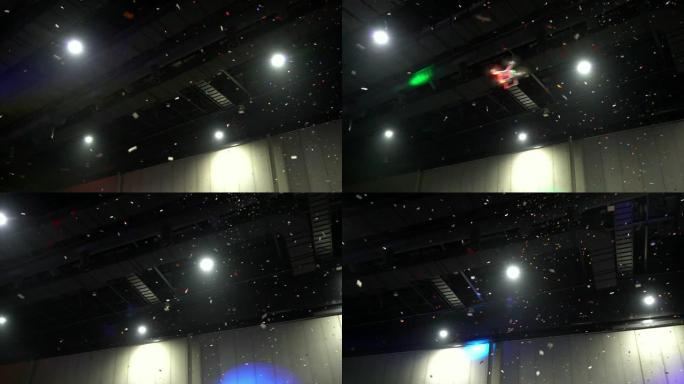 4k慢动作镜头，五颜六色的五彩纸屑从房间的上方掉落，用无人机飞行，庆祝新年快乐和派对概念