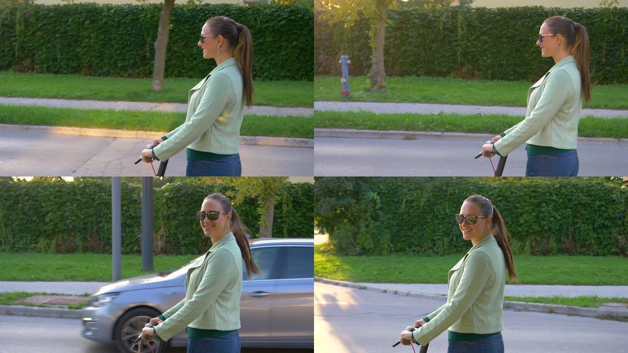 肖像: 开朗的女人骑着电动踏板车看着相机。