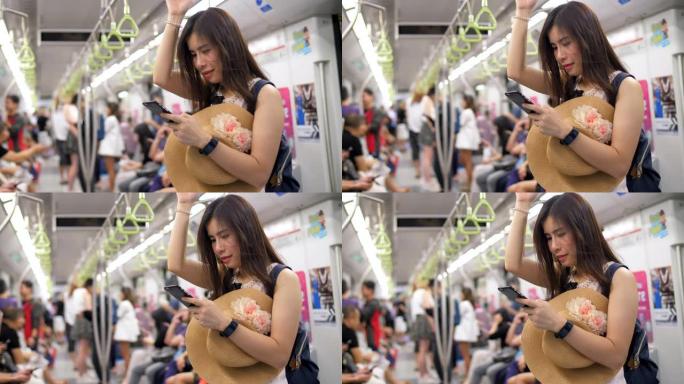 年轻女子在公共交通中使用智能手机