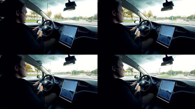 男司机用电话工作，坐在自动驾驶仪上的汽车上，特写镜头。
