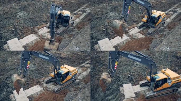 工业挖掘机正在采石场挖掘地面