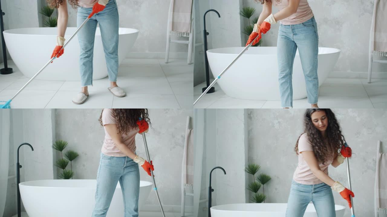 用现代拖把忙着做家务的女孩在浴室里洗地板