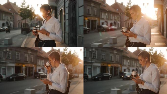 现代女商人在城市的人行道上使用智能手机
