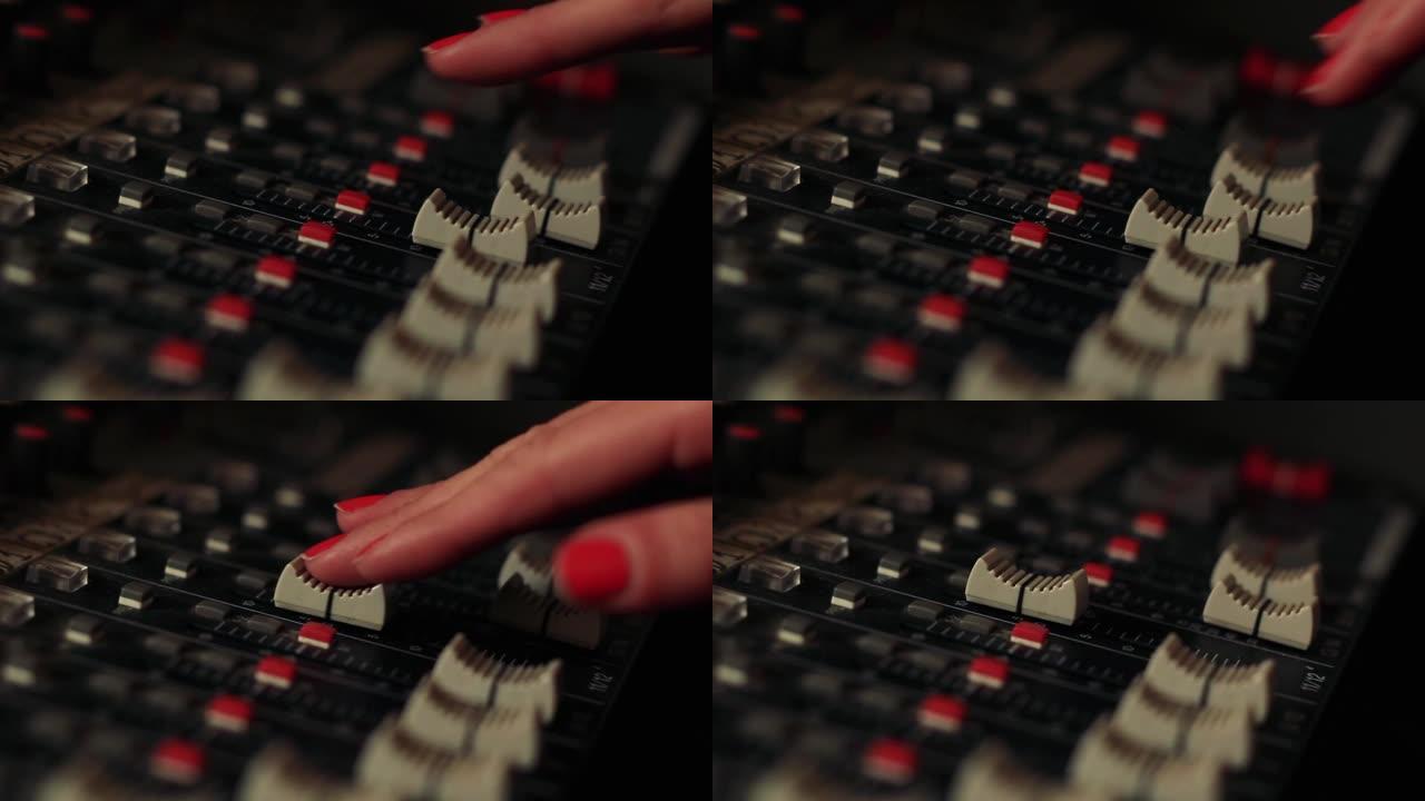女性动手数字音乐工作室混音器。特写。