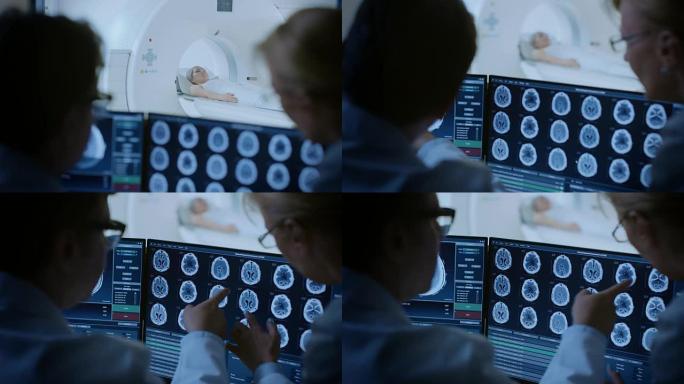 在控制室医生和放射科医生讨论诊断，同时观看程序和监视器显示脑部扫描结果，在背景患者接受MRI或ct扫