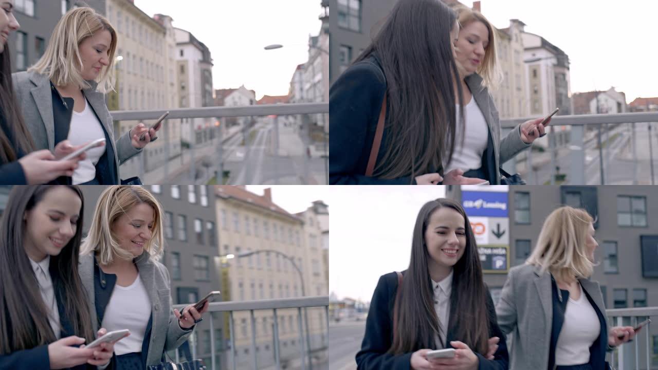 带着智能手机走在城市大桥上的快乐年轻女商人朋友