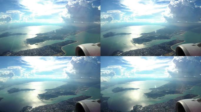 4k镜头的场景，从窗外看到美丽的山景，从空中飞过的飞机穿过云层，旅行和交通概念