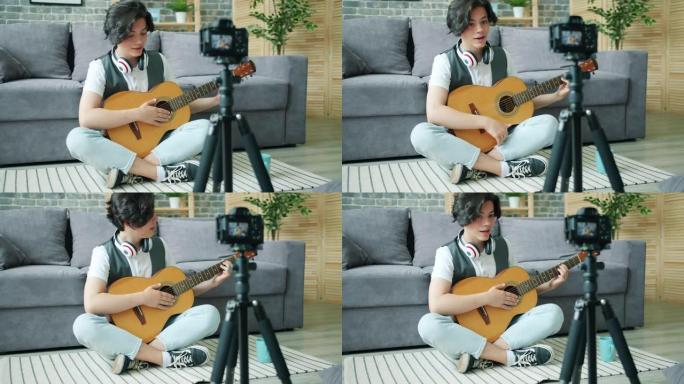 青少年吉他手在家录制互联网博客的视频
