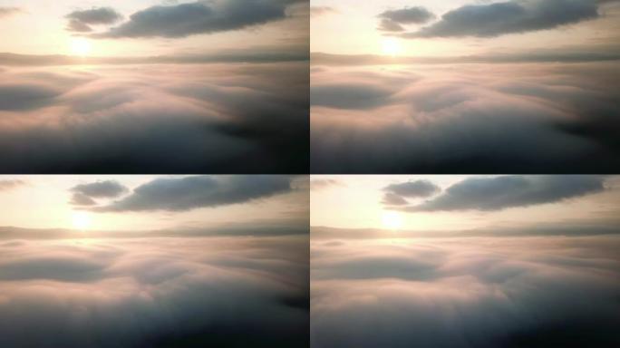 空中拍摄云层上的日出时间进入天空的薄雾向左移动