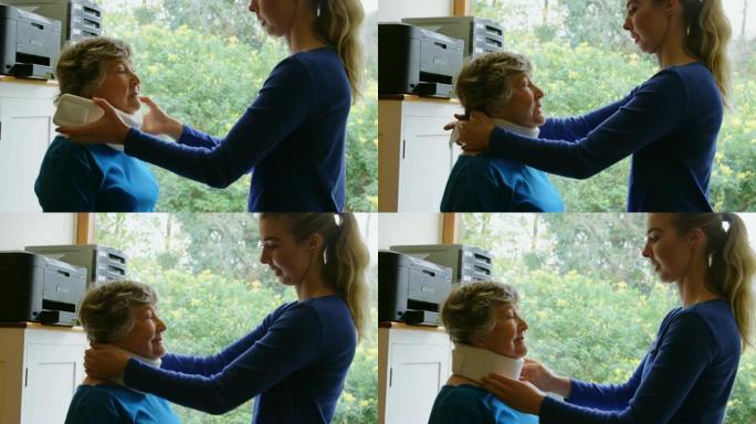 物理治疗师将颈椎项圈置于4k的高级女性身上