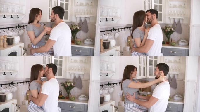 热情的情侣在厨房接吻