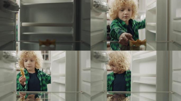 饥饿绝望的男孩看着他的空冰箱