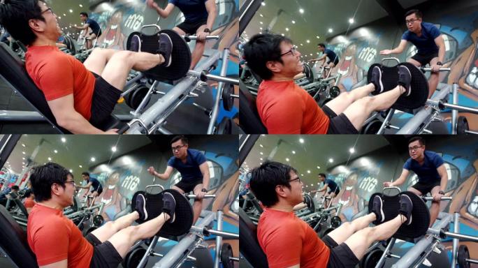 亚洲男子腿部日锻炼与朋友在健身房锻炼腿部训练。
