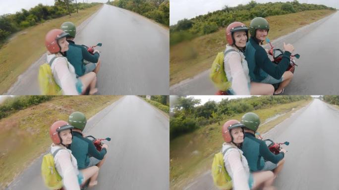 POV成年夫妇在坦桑尼亚的一条乡间小路上骑着踏板车