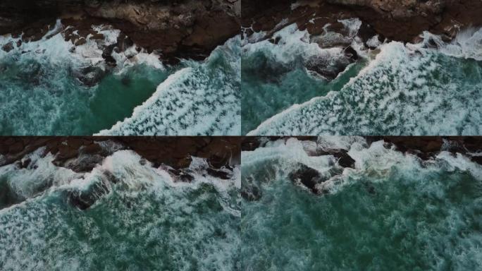 鸟瞰图和海浪撞击岩石的放大图