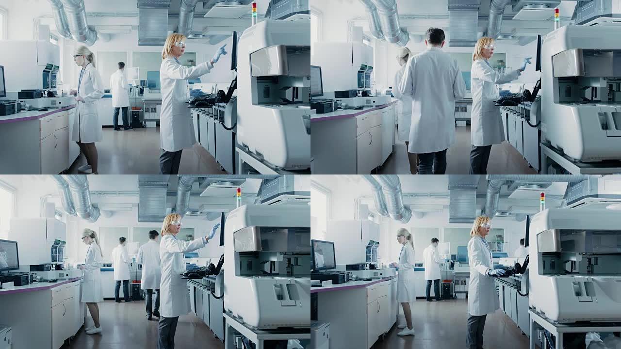 研究团队的科学家在计算机上工作，与医疗设备，分析血液和遗传物质样本与特殊的机器在现代实验室。