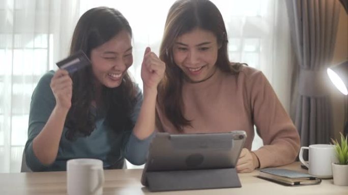 两名亚洲女子网上购物，慢动作