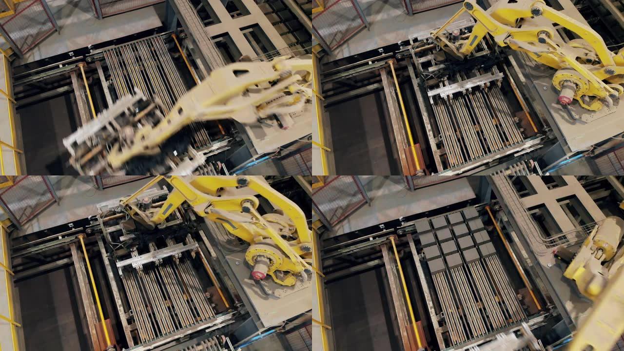 一台机器将砖块放在工厂的工作输送机上。
