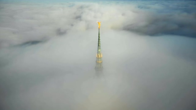 无人驾驶飞机飞向诺曼底云层上方的圣米歇尔山城堡尖顶令人惊叹的金色雕像。