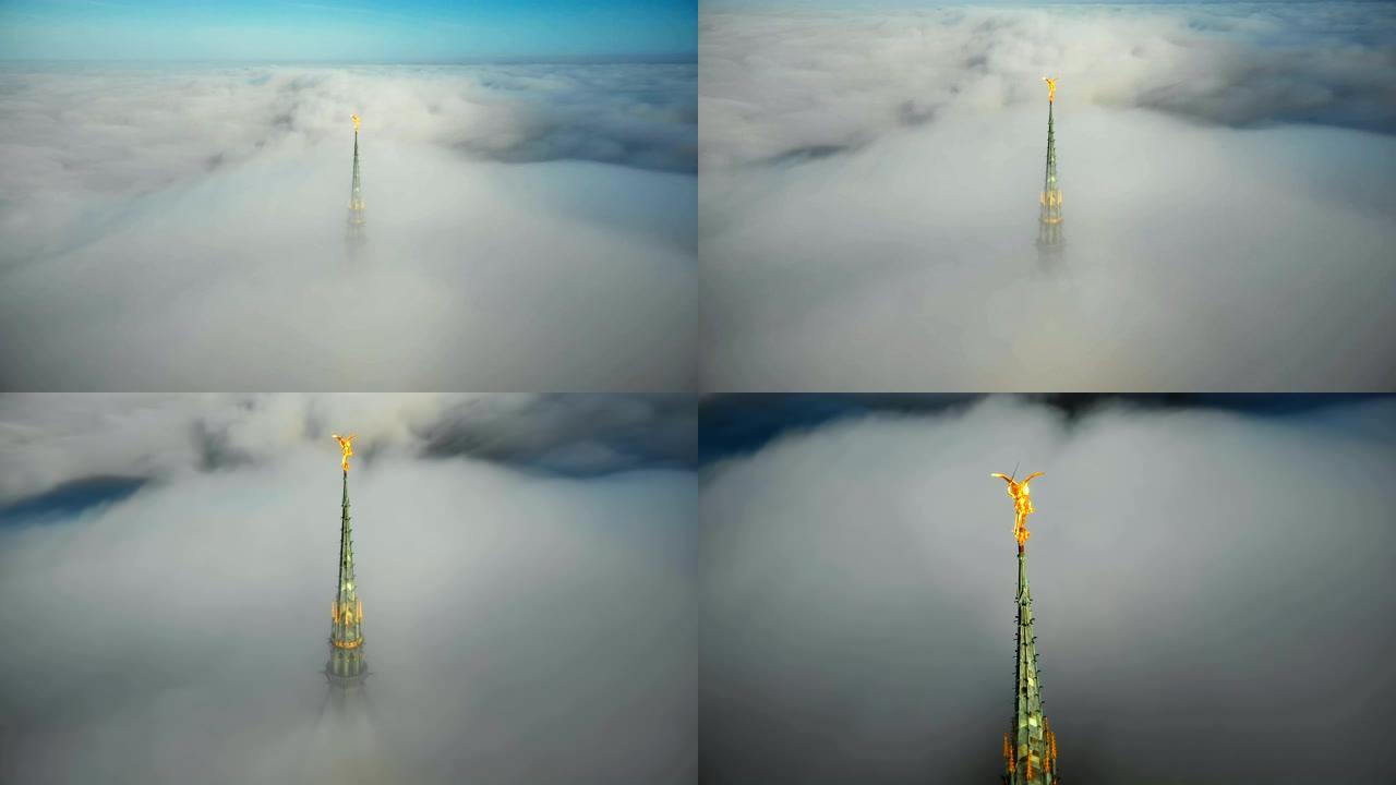无人驾驶飞机飞向诺曼底云层上方的圣米歇尔山城堡尖顶令人惊叹的金色雕像。