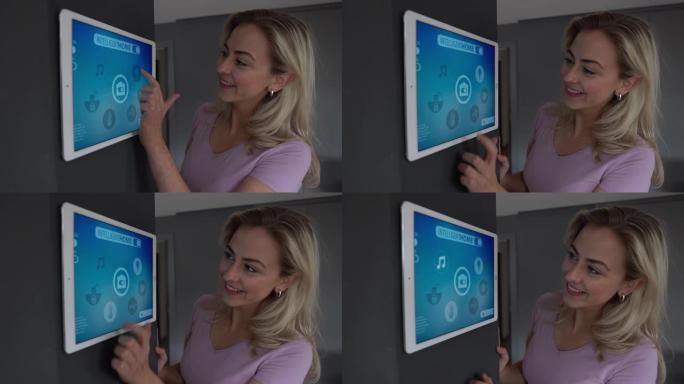 女人使用墙上的平板电脑在她的智能公寓中激活温度，灯光和音乐