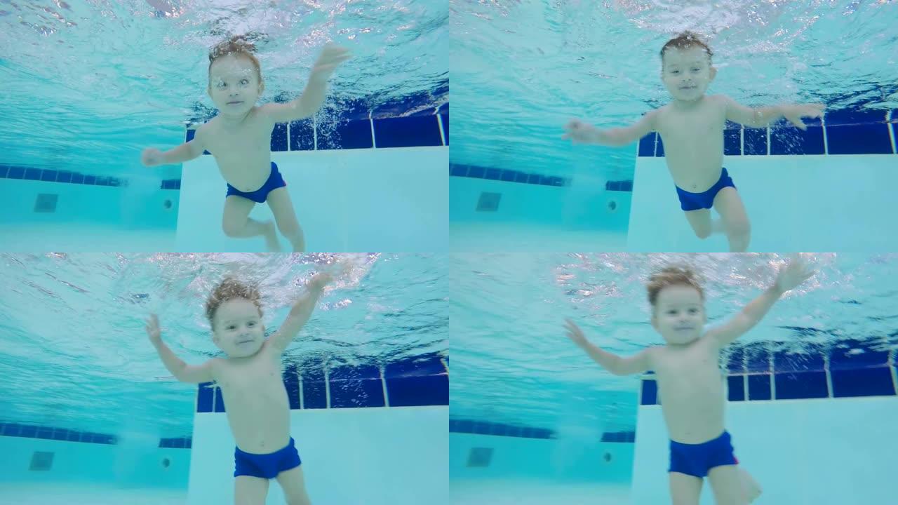 一个婴儿漂浮在游泳池的水下，特写。