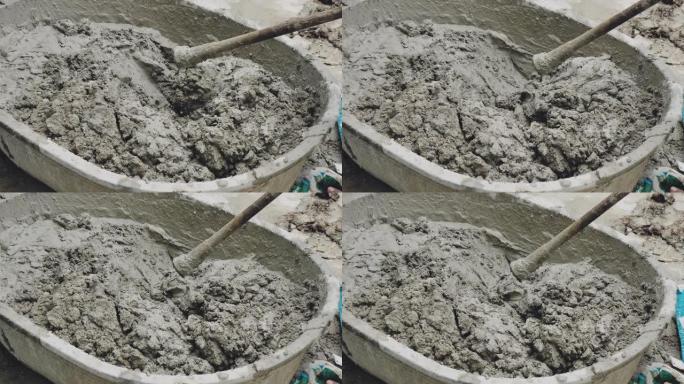 视频工人在施工现场搅拌水泥。