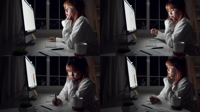 4K UHD: 亚洲女人正在家里用平板电脑工作。女人晚上努力工作。