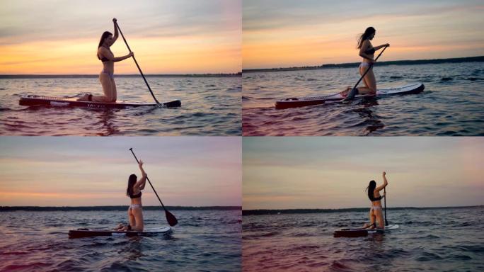 一个穿着泳衣的女人在水上划船。冲浪者使用特殊的桨骑她的木板。