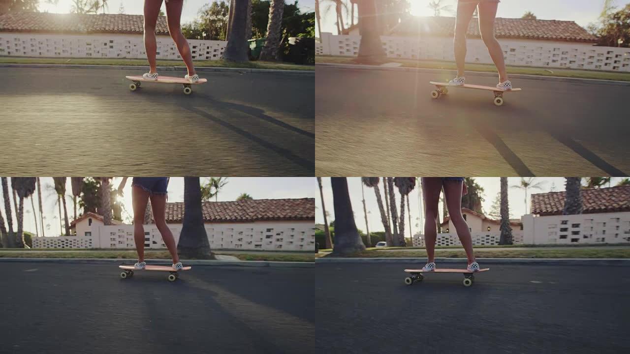 日落时女孩脚骑滑板的特写慢动作镜头