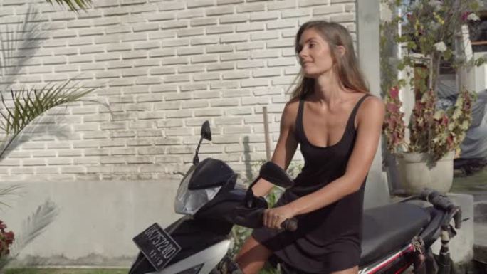 女人骑着踏板车去热带餐厅上班