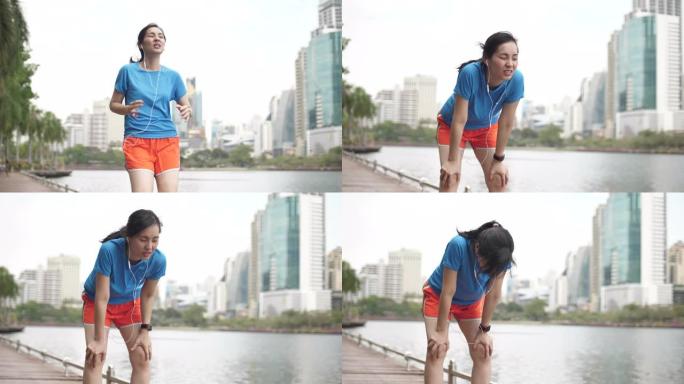 亚洲女子跑步累了，在城市里看着她的智能手表