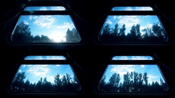 从移动火车长途汽车的窗户上看到的风景。乘火车旅行的概念。