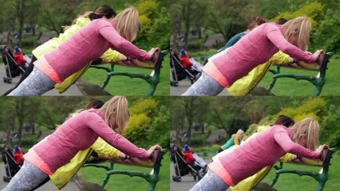 母亲在长凳上锻炼公园