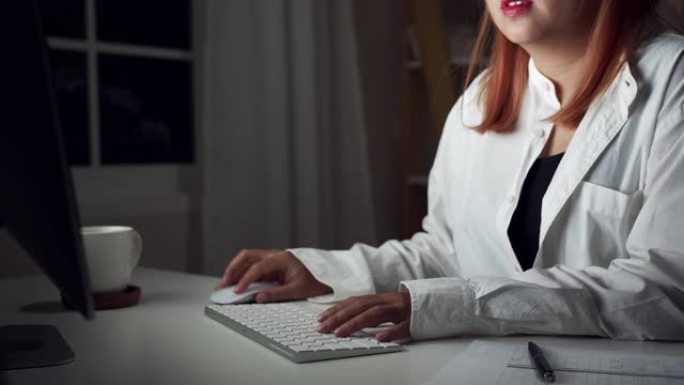 4K UHD: 关闭手的年轻女子在家庭办公室用电脑键盘在办公桌前工作