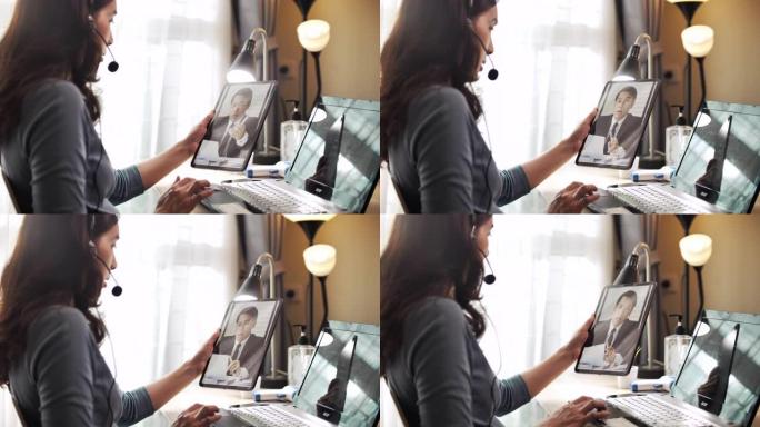 亚洲女商人在家与老板在数字平板电脑上进行视频通话