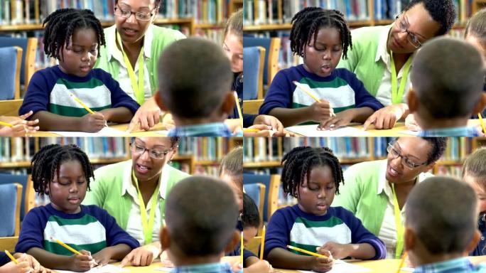 小男孩，老师，同学在图书馆写作