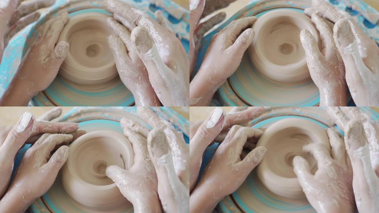 俯视图女性和儿童的手学习粘土成型。