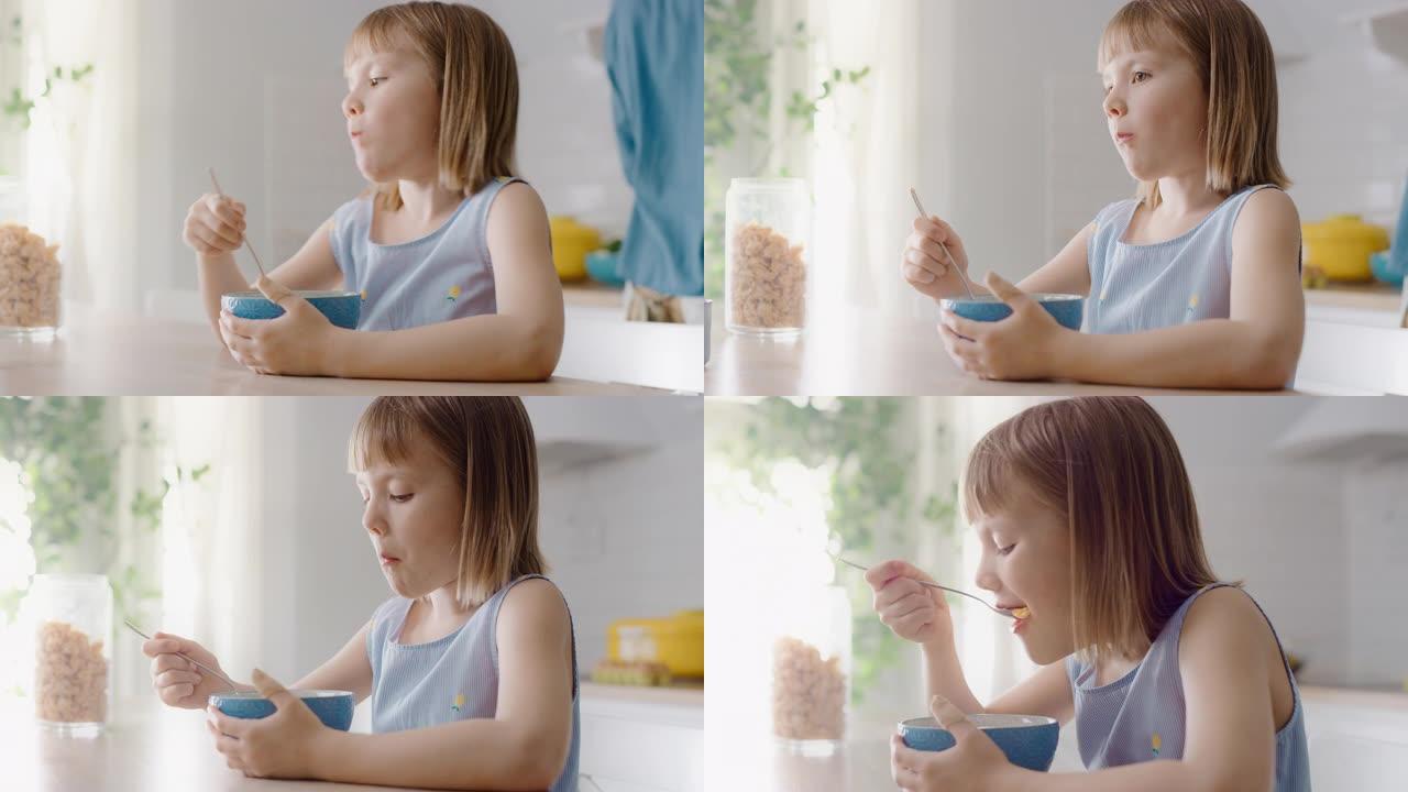 厨房早餐: 可爱的小女孩吃健康格兰诺拉麦片和碗外牛奶的肖像。她可爱的小女孩在吃早餐。在后台，有爱心的