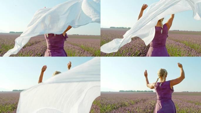 SLO MO女人把白色的围巾丢在薰衣草地里