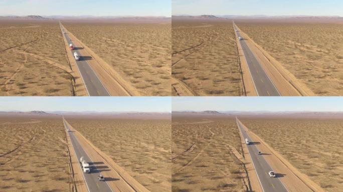 空中: 货运卡车在穿越莫哈韦沙漠的空高速公路上拖运货物。