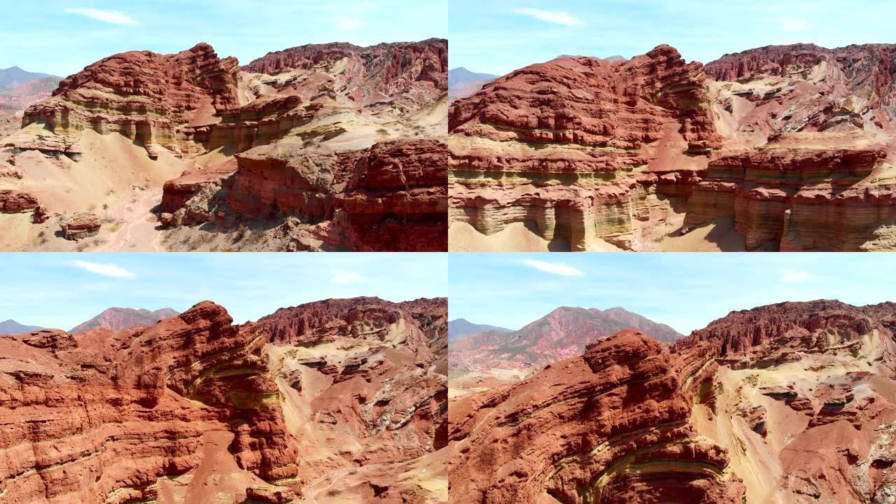 阿根廷萨尔塔周围的彩色岩石。飞越安第斯山脉南部的红色岩层。空中射击,4 k