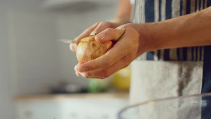 一名男子用锋利的菜刀切石榴的特写镜头。在现代厨房准备健康的有机素食小吃。天然清洁饮食和健康的生活理念