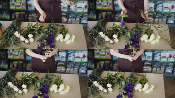 女花店在商店里拿着美丽的鲜花做花束的慢动作