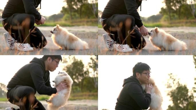 SLO MO-亚洲男子喂养并抱着他的狗